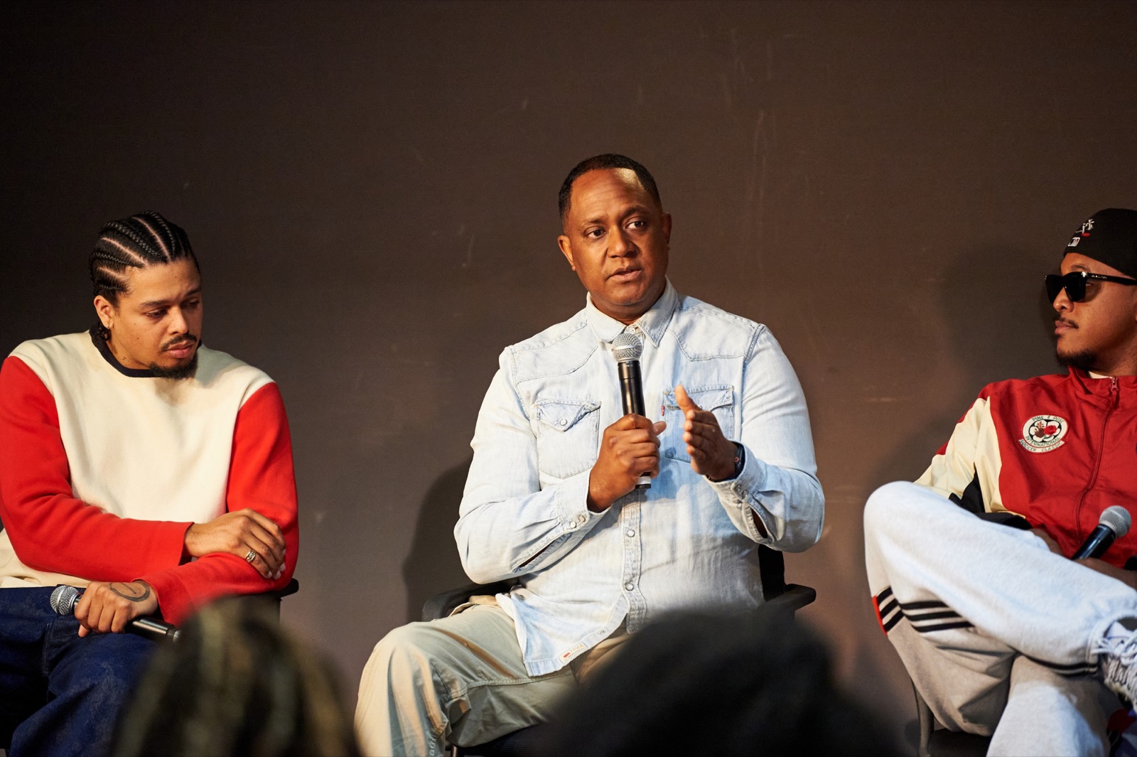 Antonio Dixon speaking on the panel between Kamal Wilson and Khris Riddick-Tynes