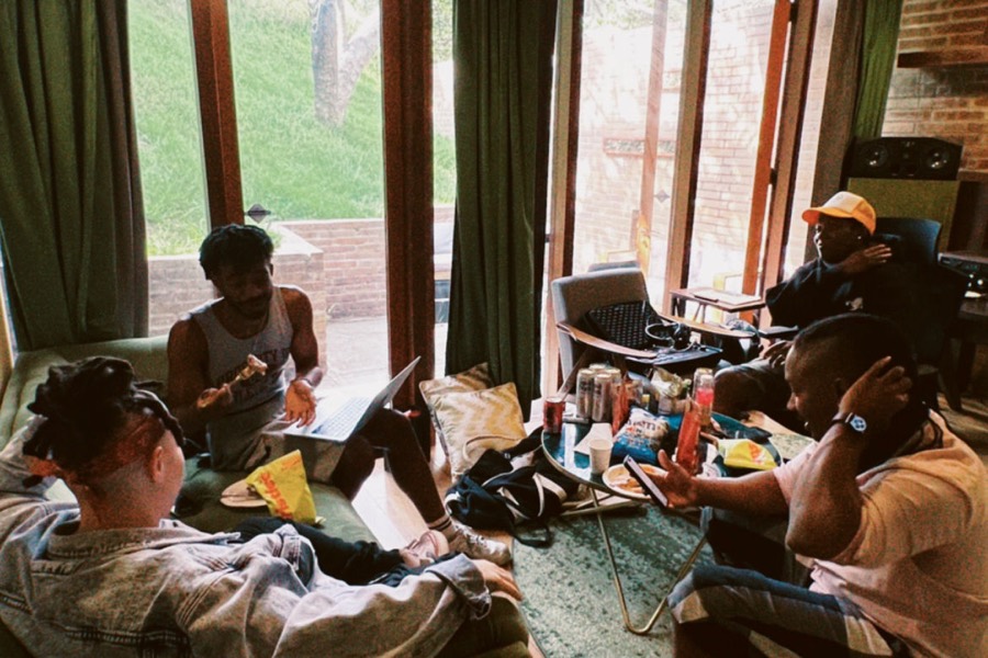 Songwriters and producers working together in a studio session